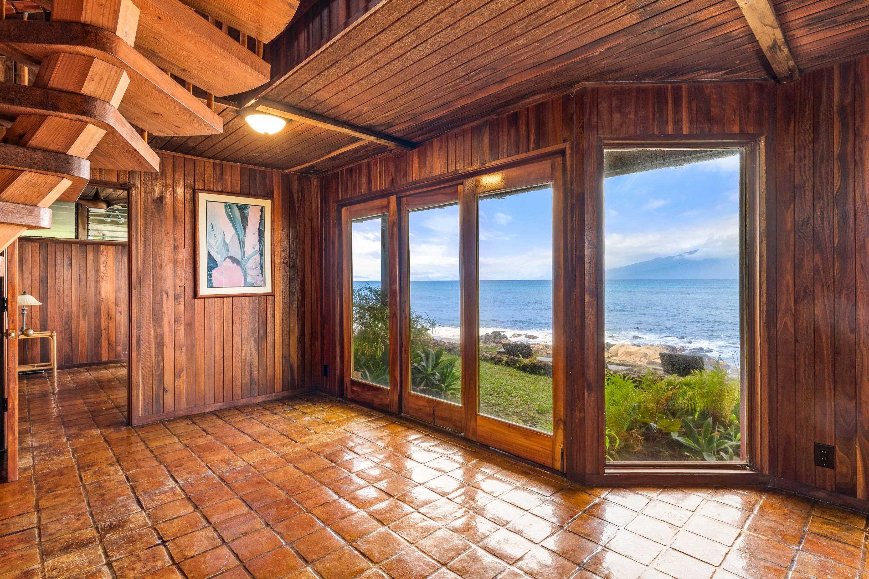Sun-warmed corner room, glossy tile floors and windows on two sides to the ocean